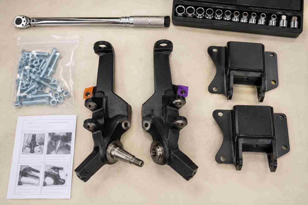 Complete EZGO lift kit laid out on a workbench with spindles, brackets, and hardware