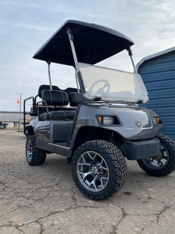 Lifted gray Yamaha gas golf cart with custom wheels and all terrain tires at Carts & Parts in Union City Indiana